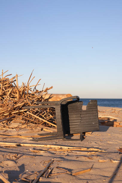 Aftermath from a flood with debris resting on a beach before entering the sea before clean up operation