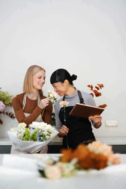 istock Two Florists Preparing Bouquets in a Flower Shop Workshop 2193518111