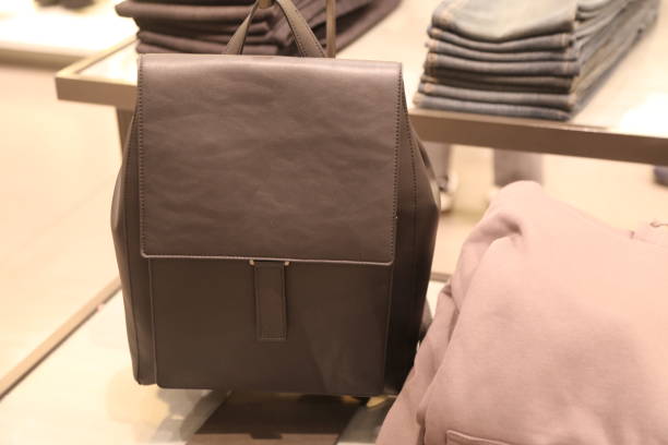 istock The gray leather backpack is on display at the store, next to some and T-shirts 2193518341