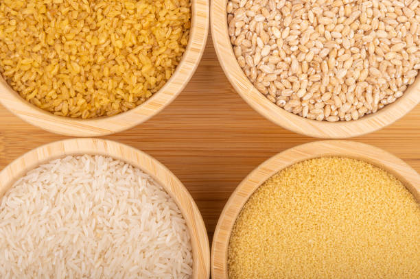 istock Assorted grains in wooden bowls on a bamboo surface 2193518666