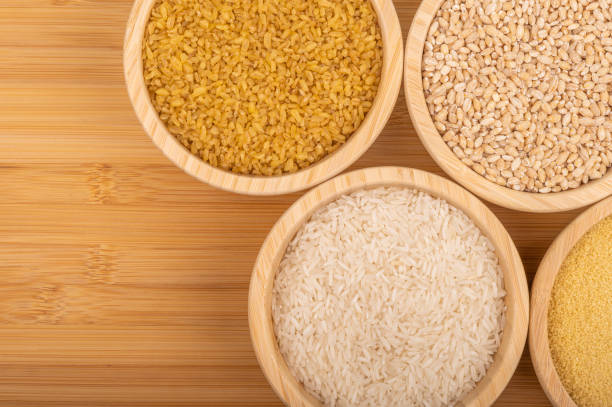 istock Assorted grains in wooden bowls on a bamboo surface 2193518677