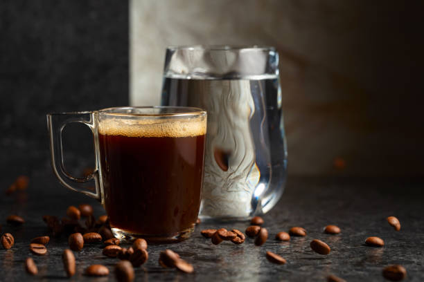 istock Espresso and glass of cold water on a black stone table. 2193520421