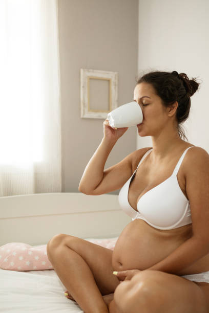 istock Young Pregnant Woman Relaxing While Drinking Tea in a Comfortable Bedroom Setting 2193522903