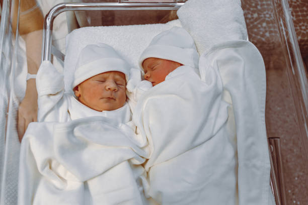 istock Newborn Twins Resting Peacefully in Hospital Crib 2193523788