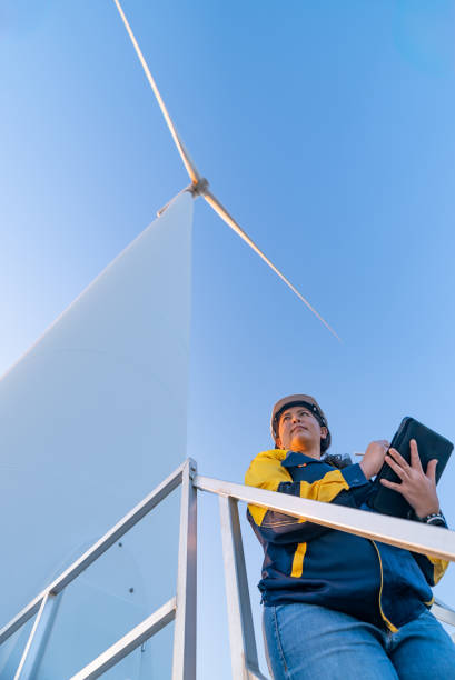 istock Professional Female Engineer Conducting Wind Turbine Inspection from Elevated Platform in Renewable Energy Facility, Nakhon Ratchasima, Thailand 2193523818