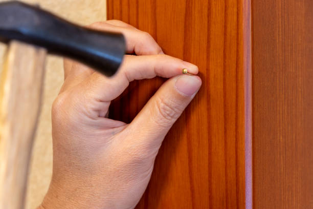 istock Hammering an metal pin into a wooden pillar 2193524054