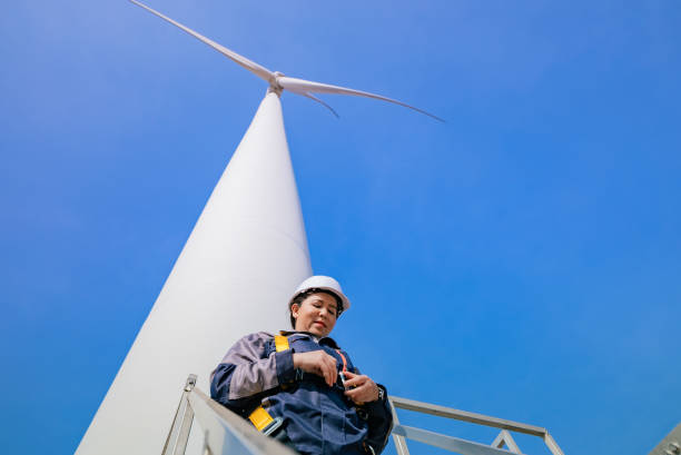 istock Asian Female Engineer Preparing for Wind Turbine Inspection by Securing Safety Harness on Elevated Platform, Nakhon Ratchasima, Thailand 2193524154