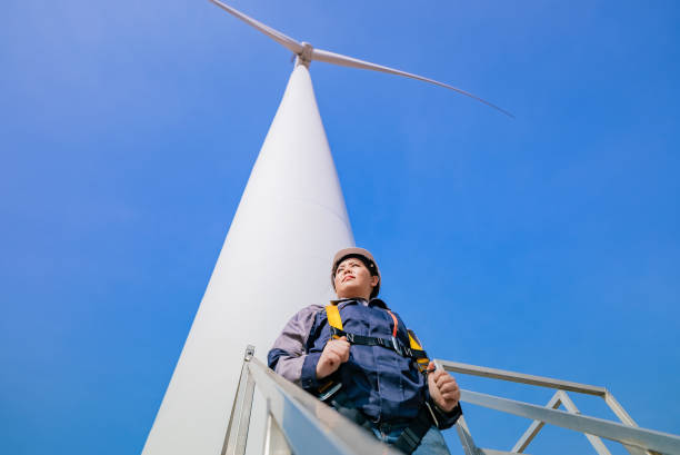 istock Asian Female Engineer Preparing for Wind Turbine Inspection by Securing Safety Harness on Elevated Platform, Nakhon Ratchasima, Thailand 2193524161