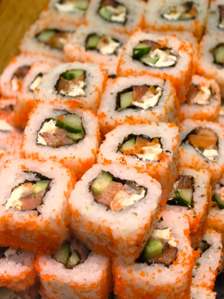 Colorful sushi rolls artfully arranged on a wooden platter ready for enjoyment