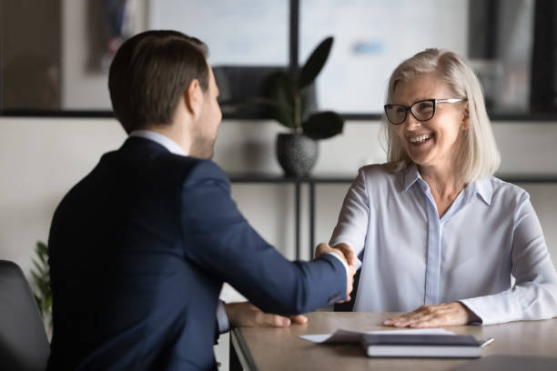 istock Two European business partners shake hands met in office 2193525760