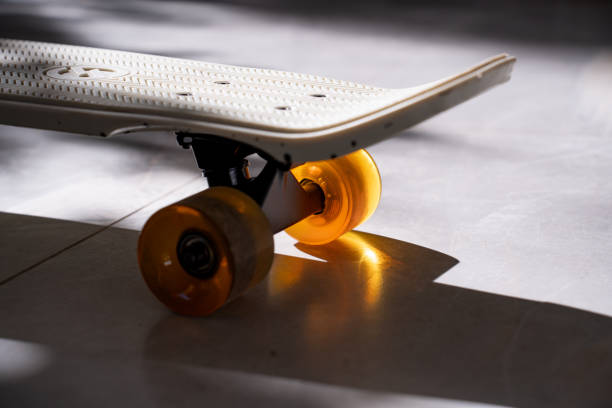 Skateboard details on shadowy ground, colorful wheel, pattern