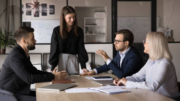 istock Group of professionals talking seated at conference table 2193526275