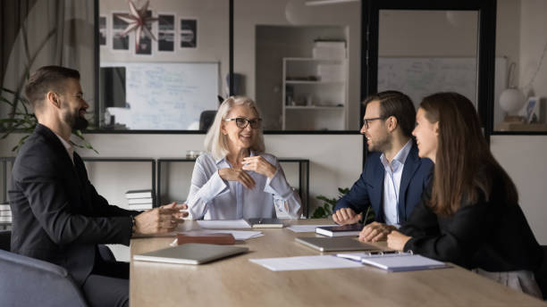 istock Employees listening mature leader, discussing strategy, making speech at briefing 2193527522