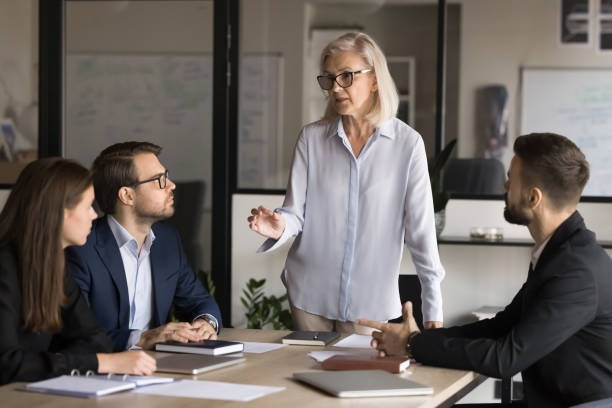 istock Company representative or coach leading negotiations or training for staff 2193528146
