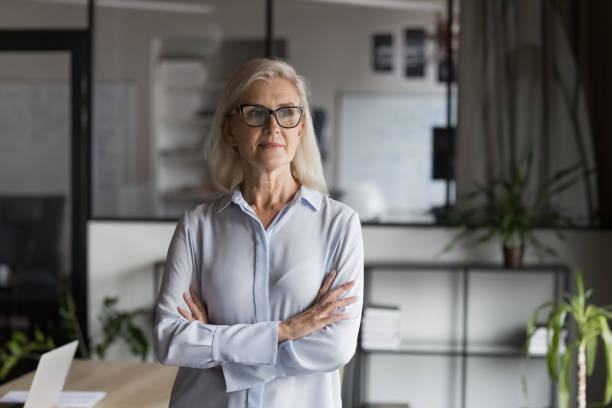 istock Middle-aged business woman posing in modern office 2193528310
