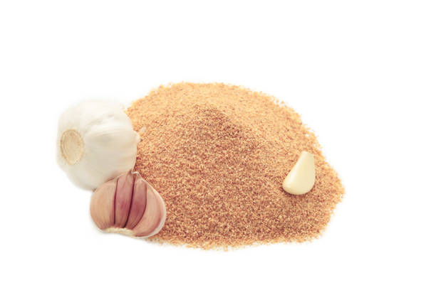 Garlic powder with garlics isolated on white background. Top view
