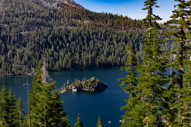 A stunning view of Emerald Bay in Lake Tahoe, Nevada, featuring deep blue waters surrounded by dense pine forests. Fannette Island sits peacefully in the center, creating a serene and iconic natural landscape.