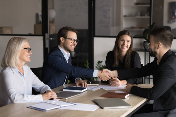 istock Two business parties shaking hands greeting each other start negotiations 2193528442