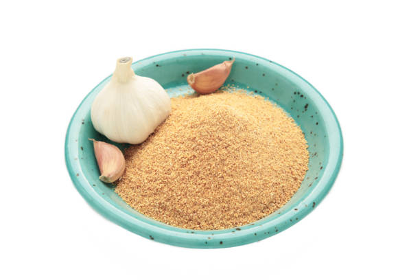 Garlic powder on plate isolated on white background