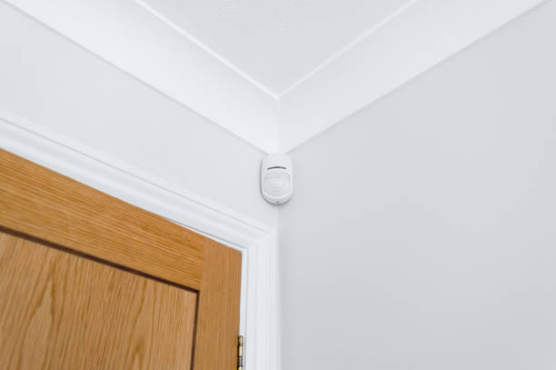 istock Newly installed wireless and battery operated new generation PIR alarm sensor in a downstairs room. 2193529532