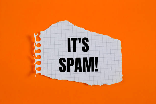 istock It's spam message written on ripped torn checkered graph paper piece with orange background 2193529830