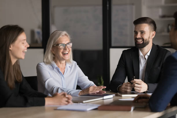 istock Laughing teammates, diverse professionals negotiating in modern boardroom 2193530315