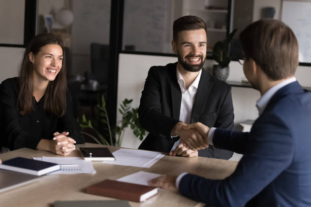 istock Businessmen start or finalize negotiations with handshake in conference room 2193530657