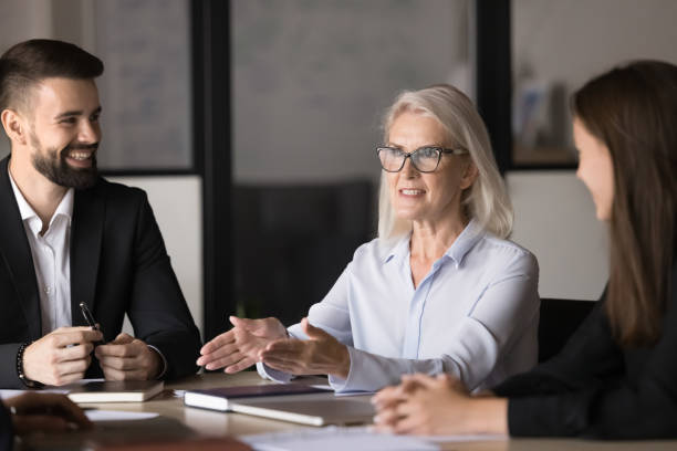 istock Middle-aged businesslady presenting detailed data of project at meeting 2193531333