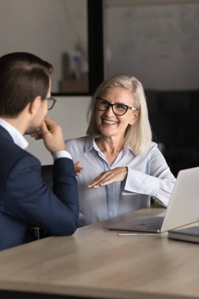 istock Smiling middle-aged bank advisor talking to client at business meeting 2193532126