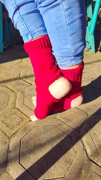 istock A person's feet in red socks on a tile floor 2193541582