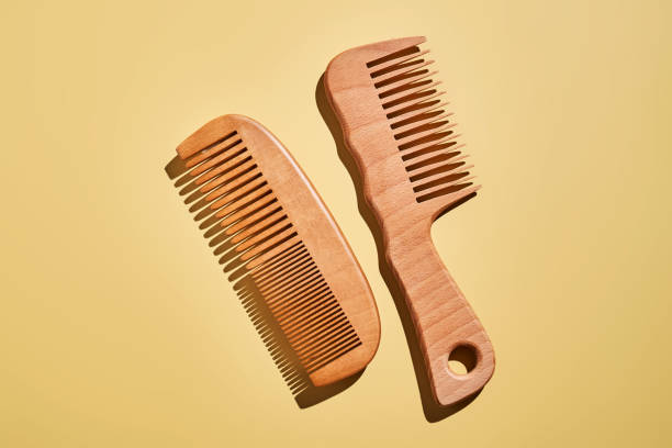 istock Two wooden combs on a yellow background. 2193544100
