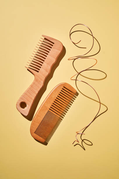 istock Two wooden combs on a yellow background. 2193544453