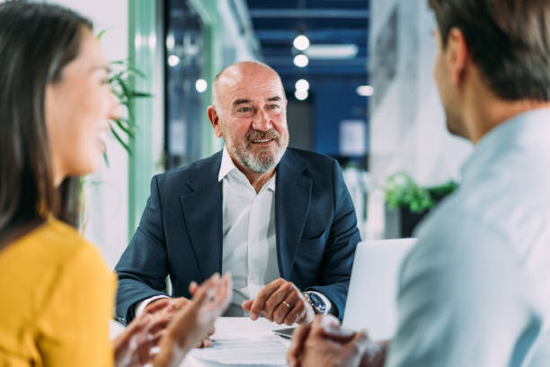 Group of business persons talking in the office.