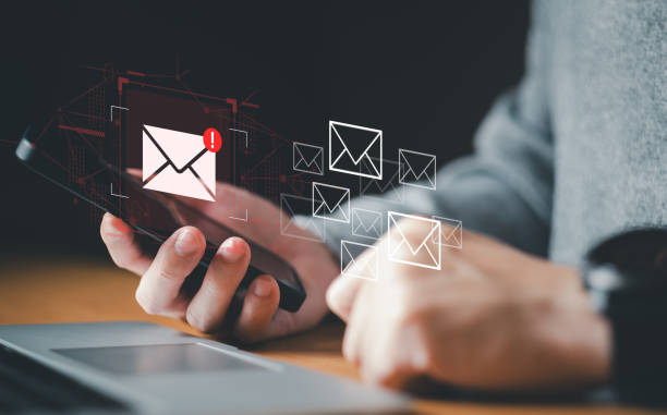 istock Business man using smartphone and computer that show warning sign after got attack phishing email by malware from hacker that commit cyber crime or software crash to cause an error. 2193548970