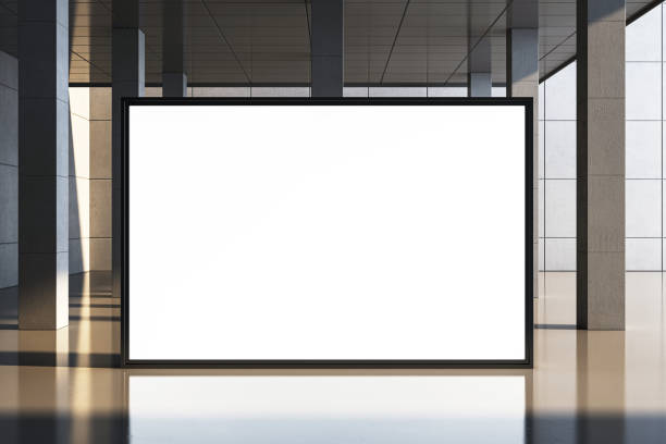 istock Blank display screen in a modern hall with concrete walls and pillars, illuminated by natural light. 3D Rendering 2193549519