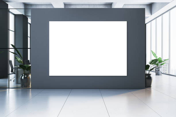 istock Modern interior with a blank white poster on a dark wall in a bright office space. 3D Rendering 2193549545