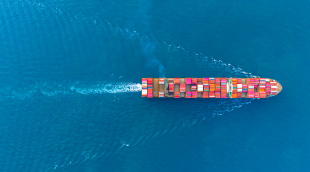 istock Top view Cargo Container ship with contrail in the ocean ship carrying container and running for import export concept technology freight shipping by ship. 2193549676