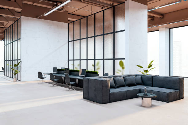 istock Modern coworking space with open layout, featuring a sleek black sofa, workstations, plants, and large frosted glass partitions. 3D Rendering 2193549801