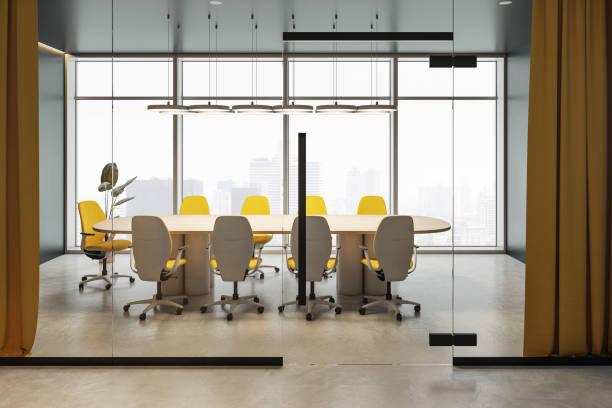 istock Contemporary boardroom with yellow chairs and a large table in a modern office space with glass walls and cityscape background. 3D Rendering 2193551553