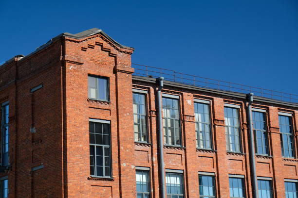 istock An old brick building in a classical style with large windows against the backdrop of the blue sky 2193554021