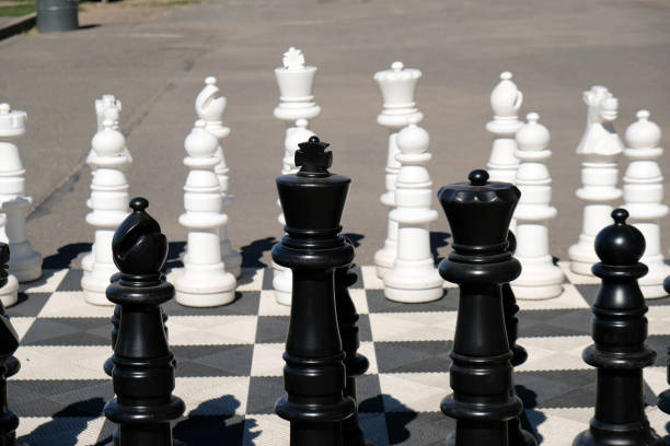 istock On the asphalt, there is a black and white chessboard drawn, with chess pieces 2193554575