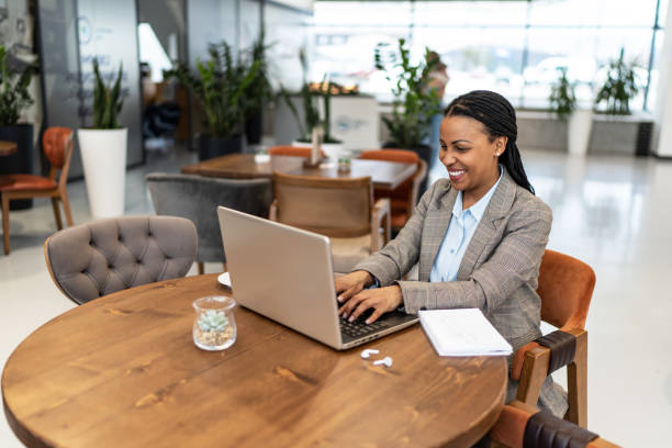 istock African woman working on laptop at cafe 2193556279