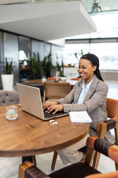 istock African woman working on laptop at cafe 2193556331