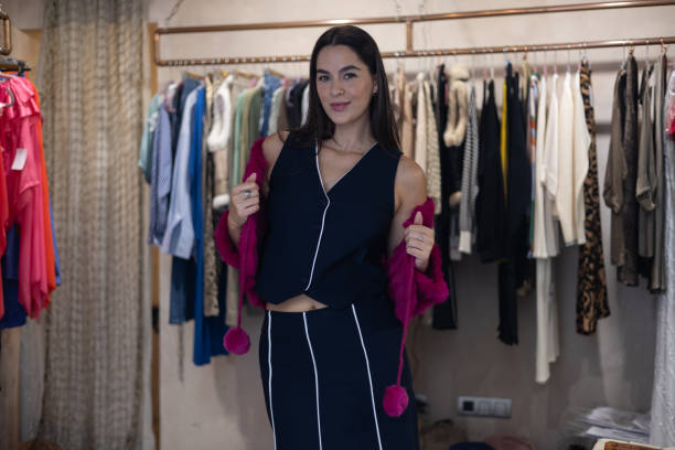 istock Fashion designer presenting new clothes collection in her workshop 2193558090