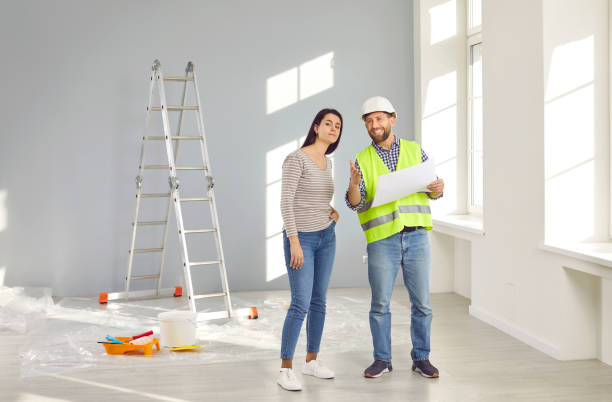 istock Builder, repairman showing house design plan to apartment owner 2193559513