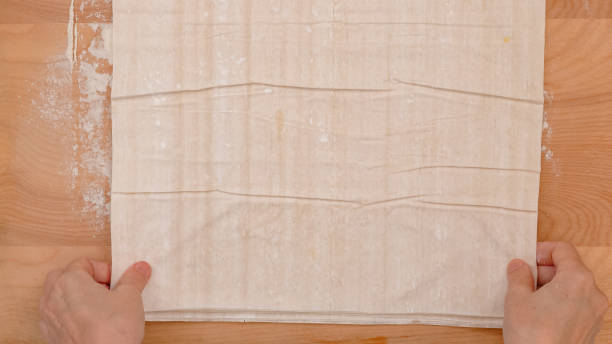 istock Brush each layer of phyllo dough with melted butter, step by step baking process 2193561852