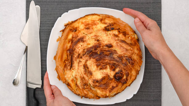 istock Chef presents a freshly baked phyllo dough pie with a golden crust, showcasing a decadent cream cheese filling 2193561865