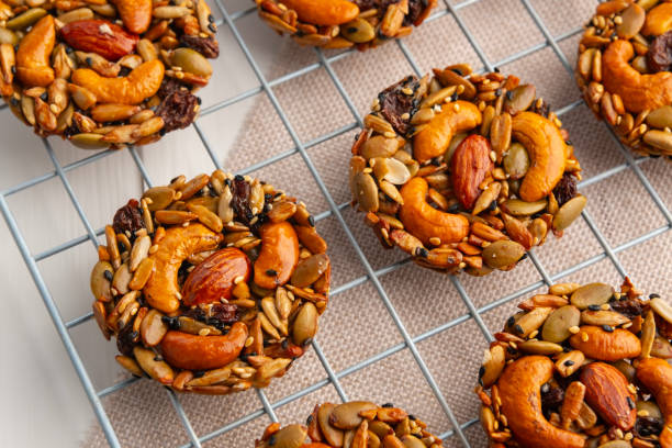 istock whole grain cookies no flour no sugar on Baking Cooling Rack.Mixed nuts, Almonds, Cashews, Peanuts, Raisins, sesame, sunflower, watermelon seed with honey cookie. 2193563966