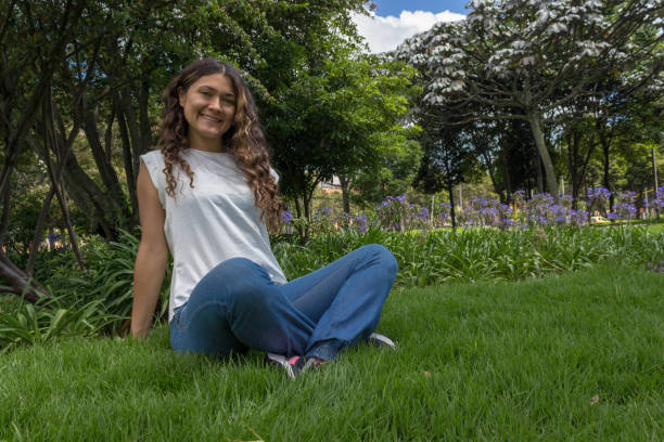 istock Beautiful young woman posing in a public park 2193566969