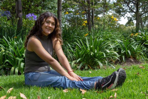 istock Beautiful young woman posing in a public park 2193567347